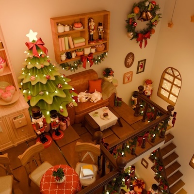 An overhead view of a cozy holiday-themed room decorated with a Christmas tree, nutcracker figures, and various festive ornaments, creating a warm and cheerful atmosphere.